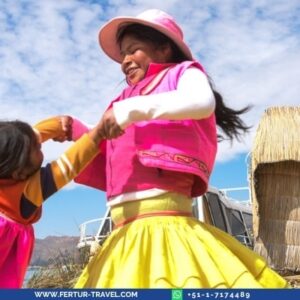 Young girls in traditional colorful Peruvian clothing playing on the Uros floating islands of Lake Titicaca in Puno, Peru