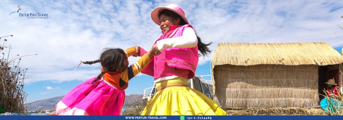 Young girls in traditional colorful Peruvian clothing playing on the Uros floating islands of Lake Titicaca in Puno, Peru